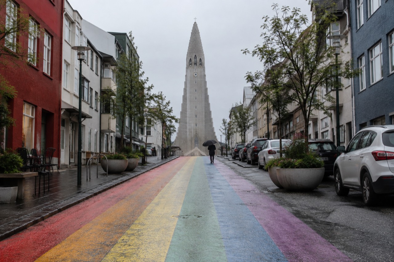 A quiet Reykjavik street with colourful houses under a wide sky