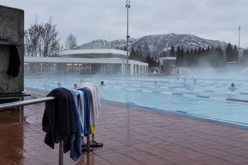 Geothermal outdoor swimming pool steaming in cool air with lanes of clear water