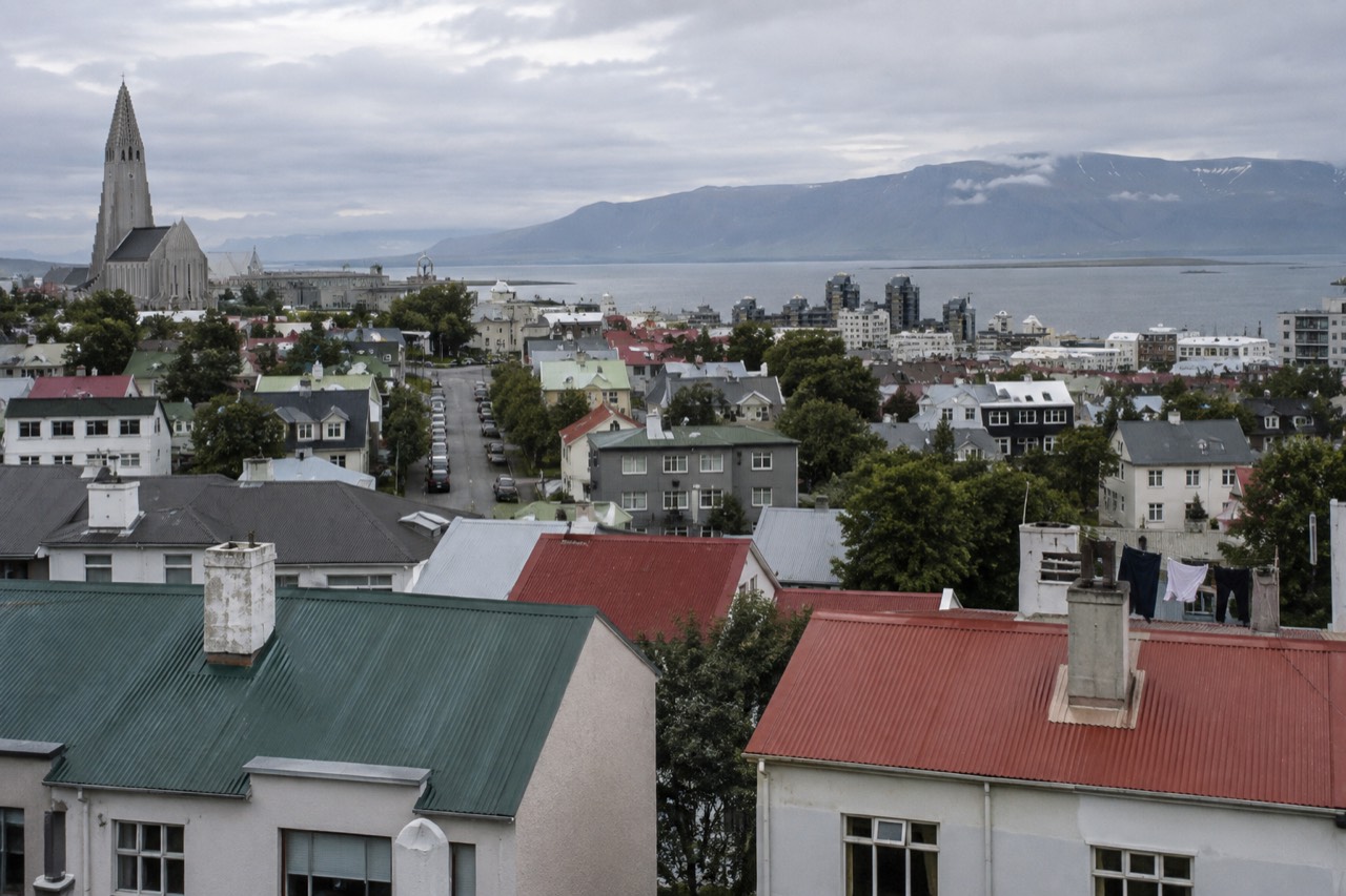 Colourful rooftops of central Reykjavik with mountains in the distance