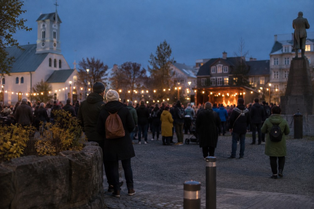 Crowd gathered in a Reykjavik square during an evening festival with lights