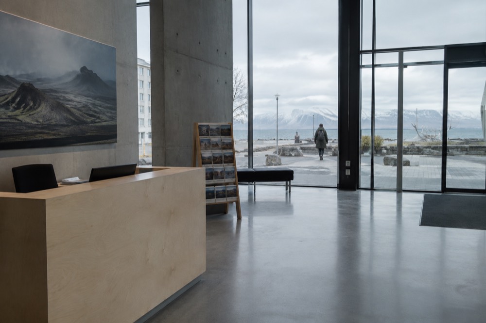 Ticket desk and information stand inside a museum lobby