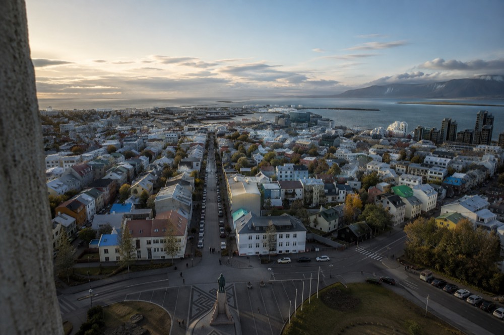 View from the Hallgrímskirkja tower over the coloured rooftops of central Reykjavik toward the sea