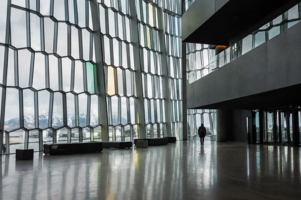 The interior lobby of Harpa Concert Hall with geometric glass panels and natural light