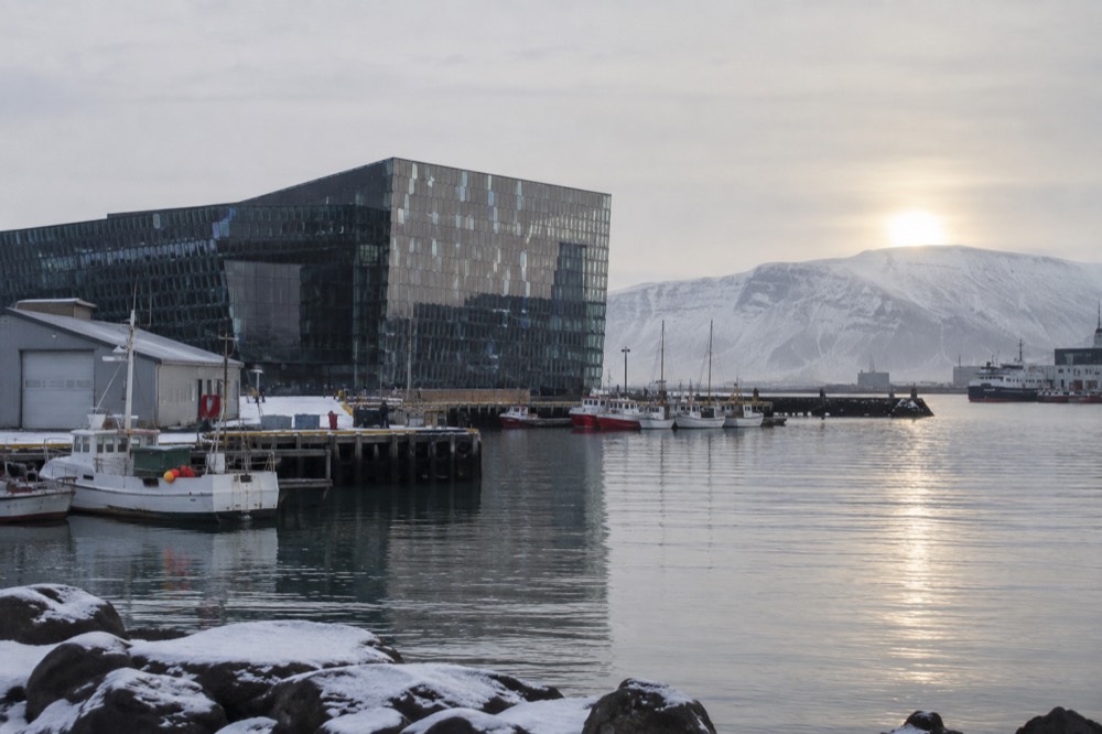 Harpa Concert Hall's location on the Reykjavik waterfront with the Old Harbour and boats in the background