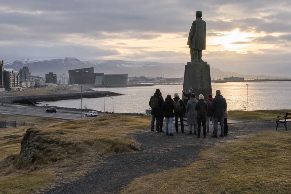 A guide speaking to a small group on a paved square in central Reykjavik