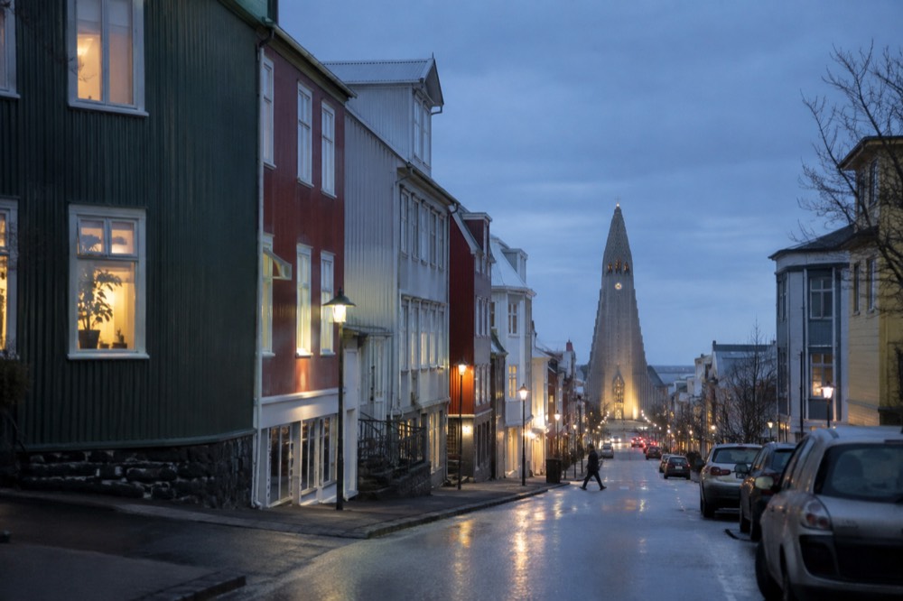 Colorful rooftops and a church spire above central Reykjavik streets