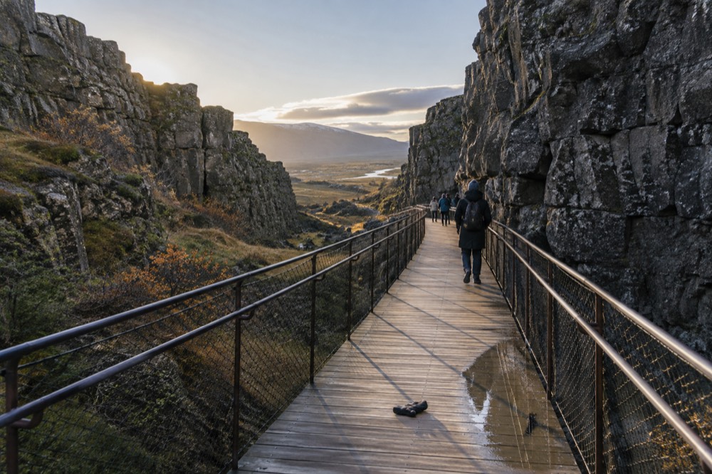 A rift valley with a wooden walkway between rock walls