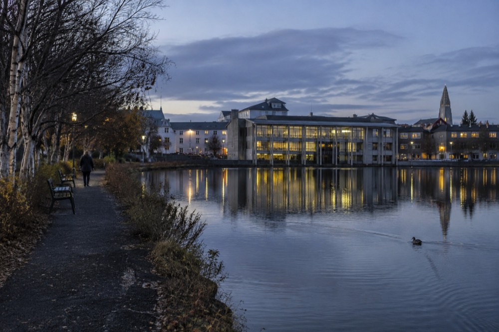 Reykjavik City Hall building at the southern corner of Tjörnin pond with water at its base